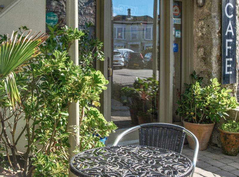 Sunlit exterior and entrance of Café Dog & Rabbit Cafe on North Row, St Just, Penwith