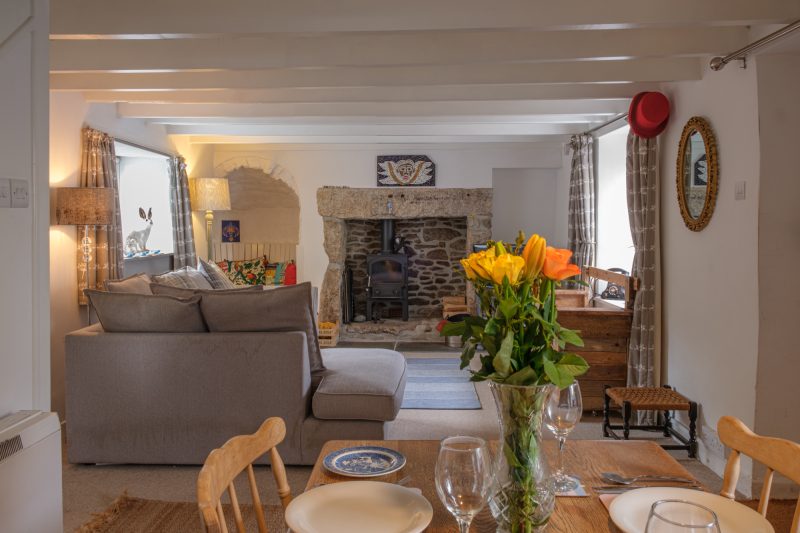 The dining area and sitting room in Banjo Cottage